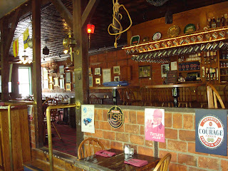 The Ship Inn dining room interior with tin ceiling and wooden tables